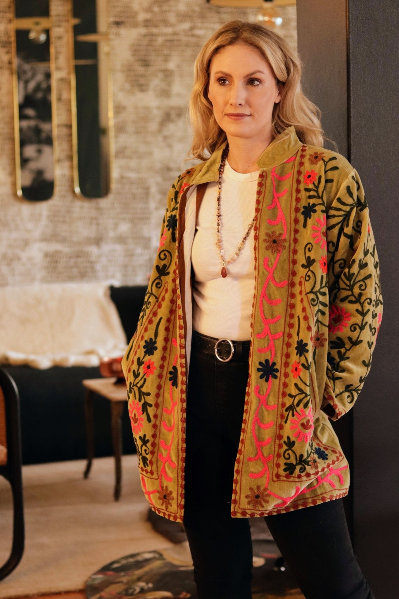 Woman wearing a patterned jacket in an indoor setting